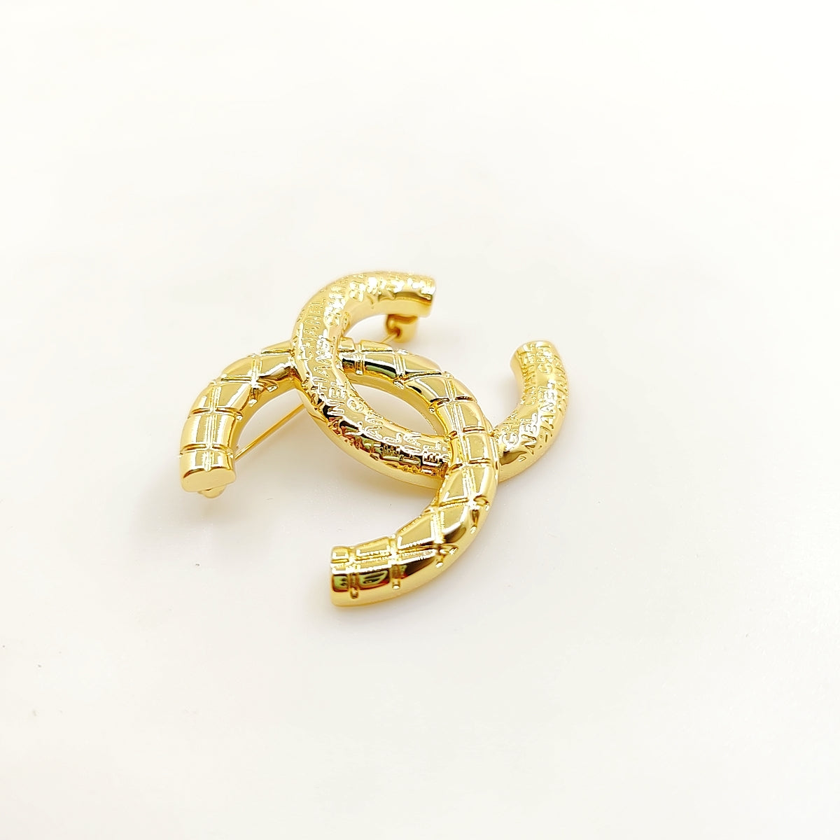 18K CC 24S Brooch