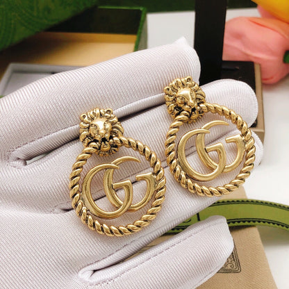 Boucles d'oreilles pendantes Double G 18 carats