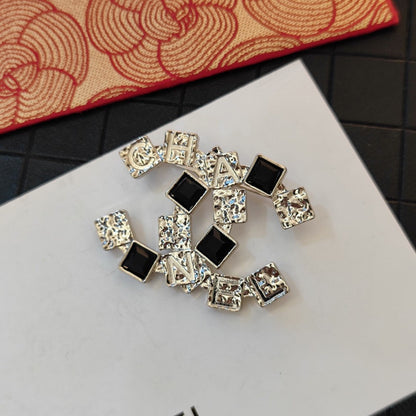 18K CC Black Crystals Brooch