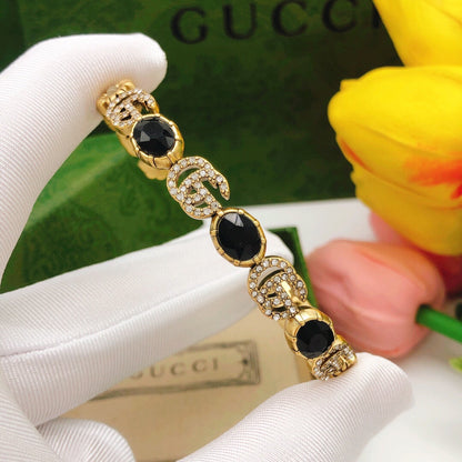 Bracelet manchette ouvert avec cristaux noirs et fleurs Double G 18 carats