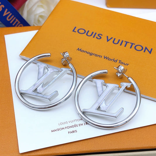 Silver hoop earrings with Louis Vuitton logo on a Louis Vuitton packaging