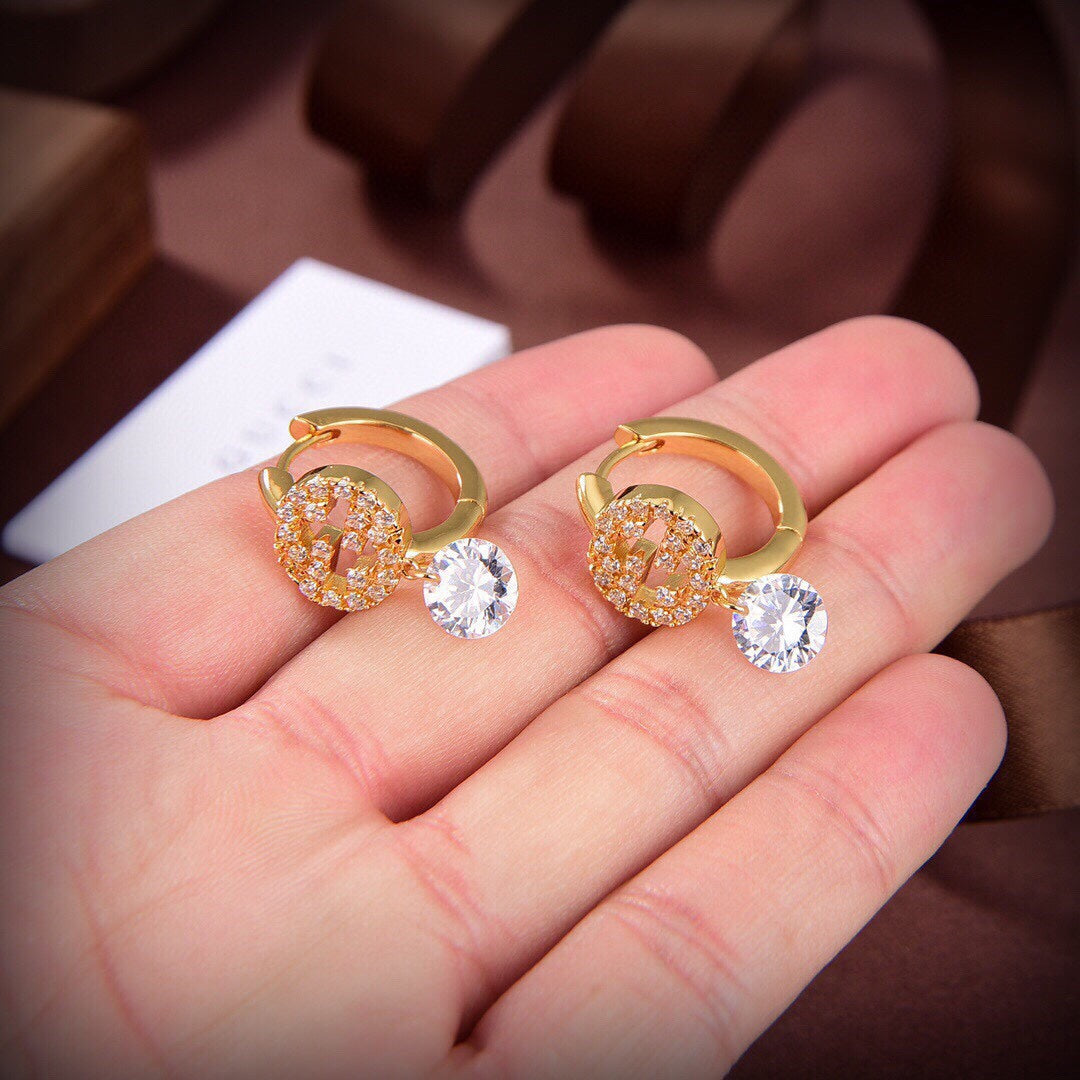 Boucles d'oreilles à diamants G entrelacés Double G 18 carats