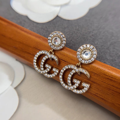 Boucles d'oreilles pendantes en cristal Double G 18 carats